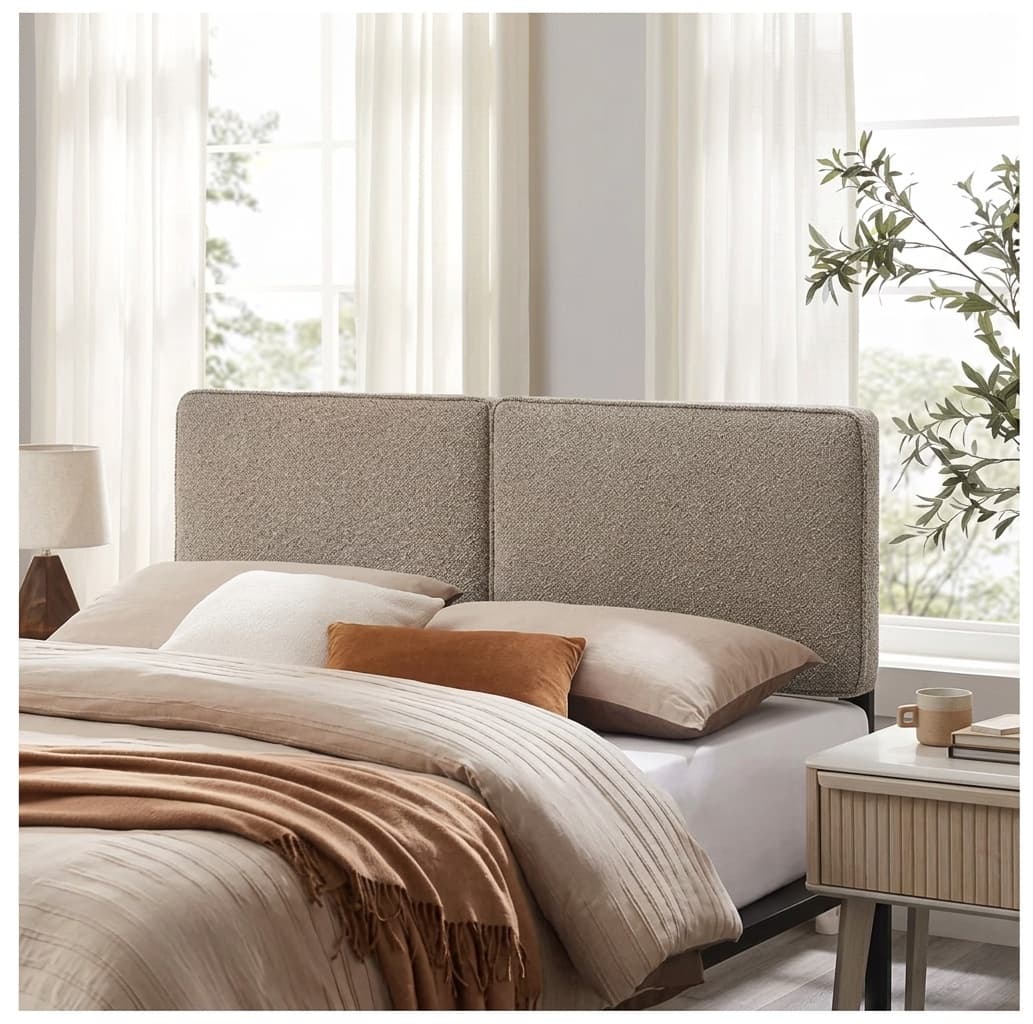 Boucle upholstered headboard in oatmeal on a queen bed with layered neutral bedding